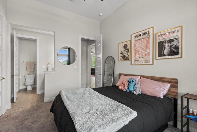 carpeted bedroom with baseboards and ensuite bathroom