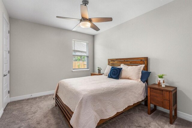 carpeted bedroom with baseboards and a ceiling fan
