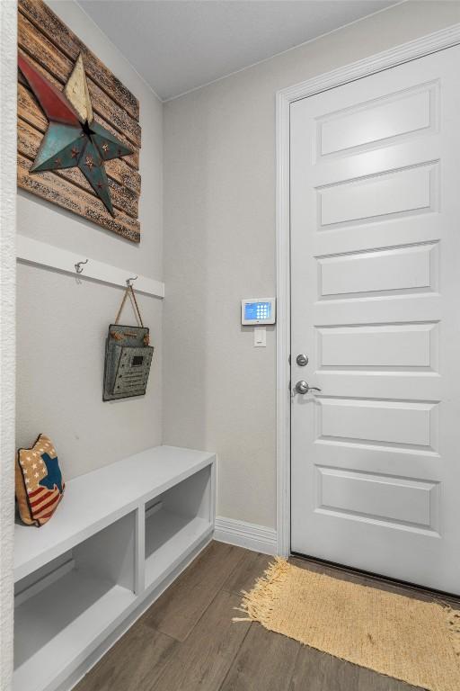 mudroom with baseboards and dark wood-style floors