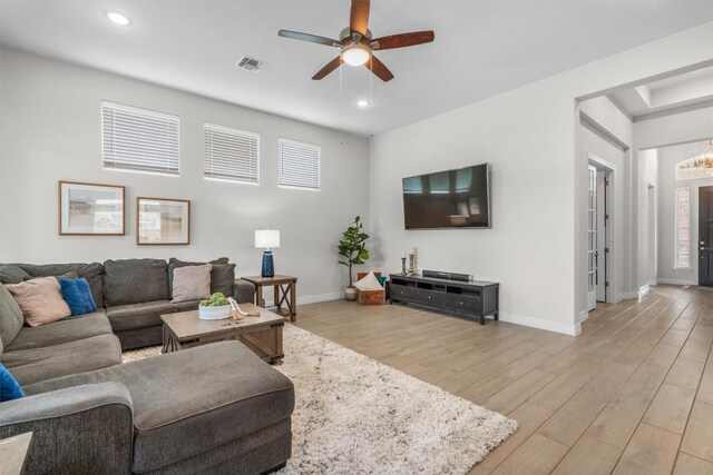living area featuring ceiling fan, visible vents, baseboards, recessed lighting, and light wood-style flooring