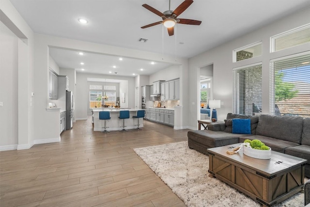 2217 Belen Dr, Leander, TX 78641 - living area with light wood-type flooring, a ceiling fan, recessed lighting, and baseboards
