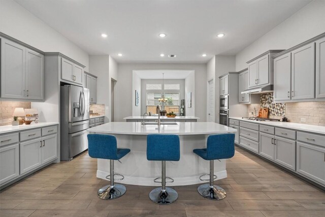 kitchen featuring a sink, gray cabinetry, and stainless steel appliances
