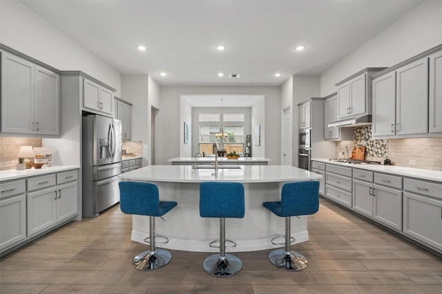 2217 Belen Dr, Leander, TX 78641 - kitchen featuring gray cabinetry, stainless steel appliances, a sink, and recessed lighting