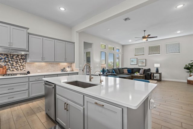 2217 Belen Dr, Leander, TX 78641 - kitchen featuring a sink, gray cabinetry, ceiling fan, light wood-style flooring, and under cabinet range hood