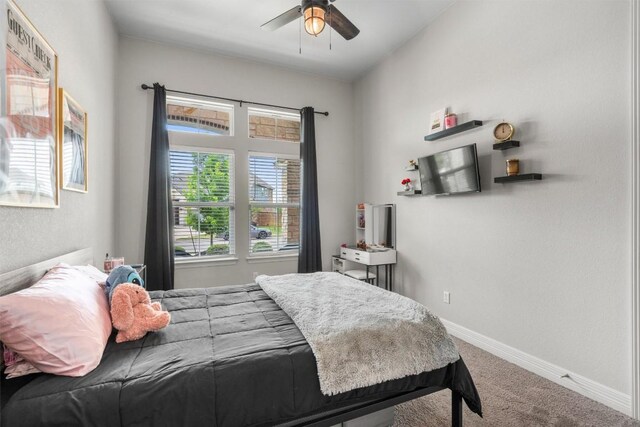 bedroom with baseboards, a ceiling fan, and carpet