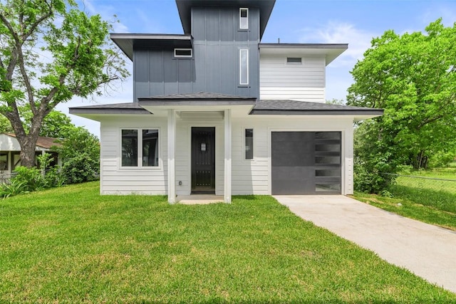 1000B Vargas Rd Unit B, Austin, TX 78741 - view of front of property featuring a garage, fence, a front yard, board and batten siding, and concrete driveway