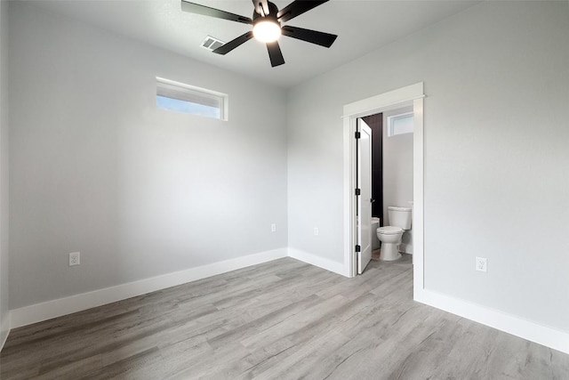 1000B Vargas Rd Unit B, Austin, TX 78741 - unfurnished bedroom featuring ceiling fan, visible vents, wood finished floors, baseboards, and ensuite bath