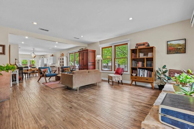 living area featuring visible vents, recessed lighting, and light wood finished floors