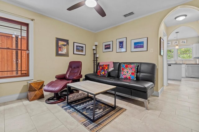 5414 Duval St, Austin, TX 78751 - living area featuring a ceiling fan, light tile patterned floors, crown molding, and arched walkways