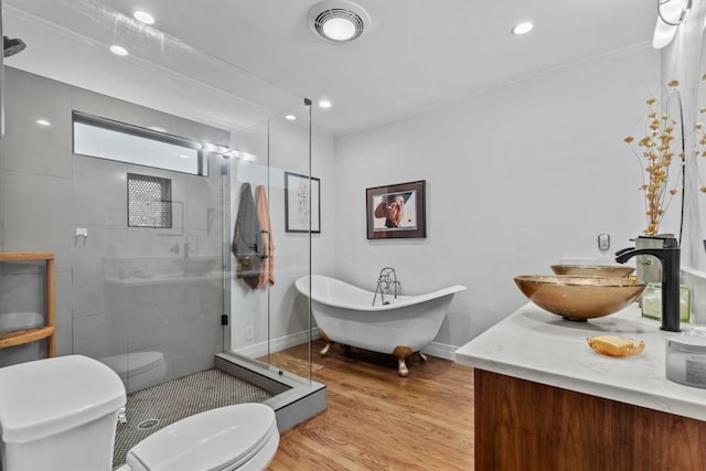 5414 Duval St, Austin, TX 78751 - full bath featuring a stall shower, vanity, a freestanding tub, wood finished floors, and recessed lighting