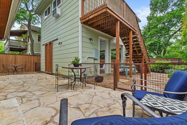 view of patio / terrace with stairs and fence private yard