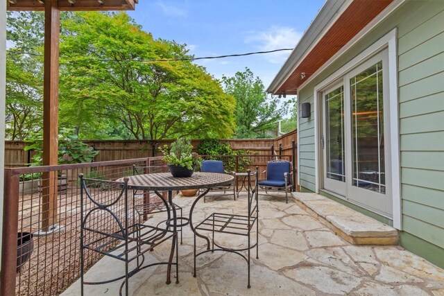 view of patio with outdoor dining area and a fenced backyard
