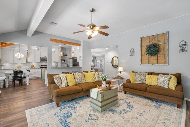 living area with vaulted ceiling with beams, ceiling fan, visible vents, and wood finished floors