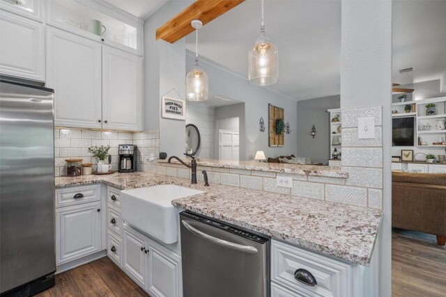 kitchen with decorative backsplash, dark wood finished floors, beam ceiling, stainless steel appliances, and white cabinetry