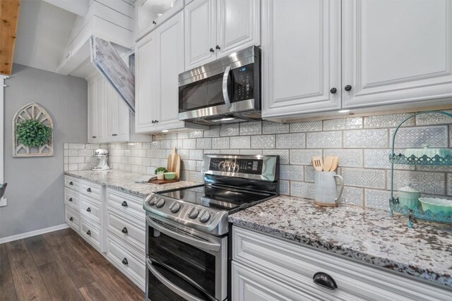 kitchen featuring white cabinets, baseboards, appliances with stainless steel finishes, and dark wood-style floors