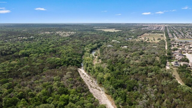 drone / aerial view featuring a forest view