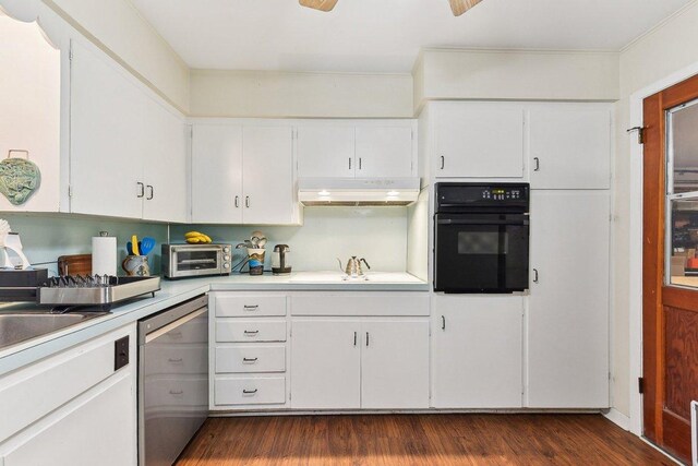 kitchen featuring stainless steel dishwasher, black oven, light countertops, under cabinet range hood, and white cabinets