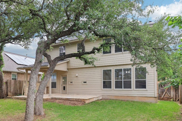 back of house featuring a patio, fence, and a yard