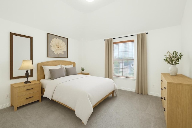 bedroom with baseboards and light colored carpet