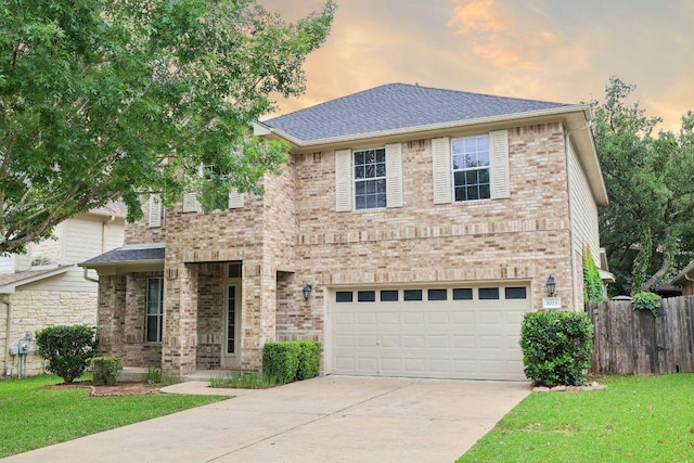 view of front of house with a front yard, a garage, brick siding, fence, and concrete driveway