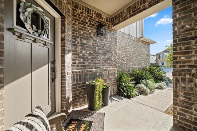 property entrance featuring brick siding