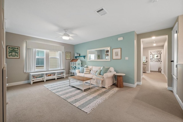 living room featuring baseboards, ceiling fan, carpet flooring, and visible vents