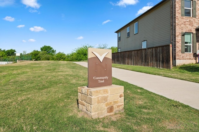 exterior details featuring brick siding and fence