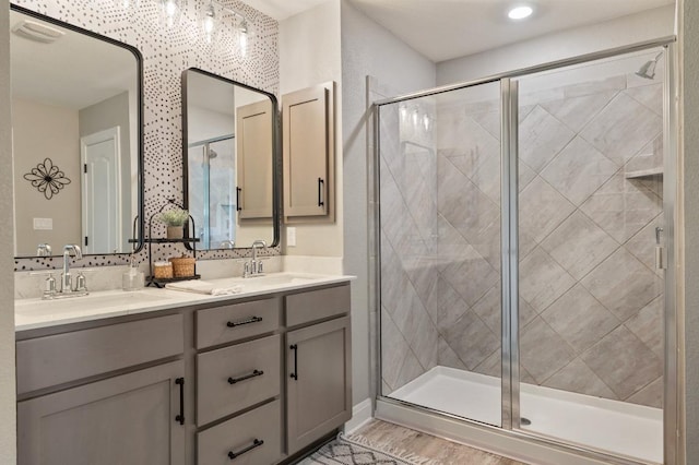 bathroom featuring a sink and a stall shower