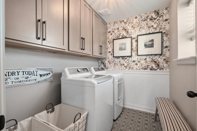 laundry area featuring wainscoting, washing machine and dryer, wallpapered walls, a sink, and cabinet space