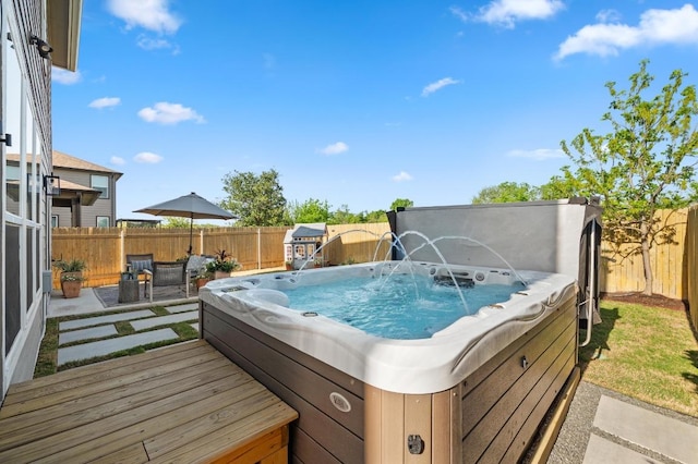 exterior space featuring a fenced backyard and a hot tub
