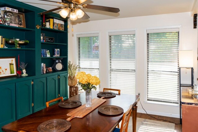 dining area with ceiling fan and wood finished floors
