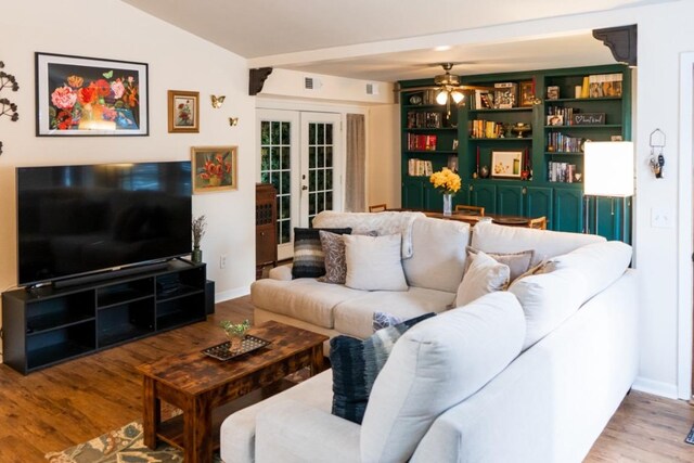 living area with french doors, a ceiling fan, visible vents, wood finished floors, and baseboards