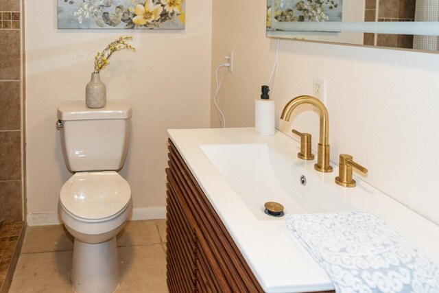 full bath with vanity, tile patterned flooring, toilet, and tiled shower