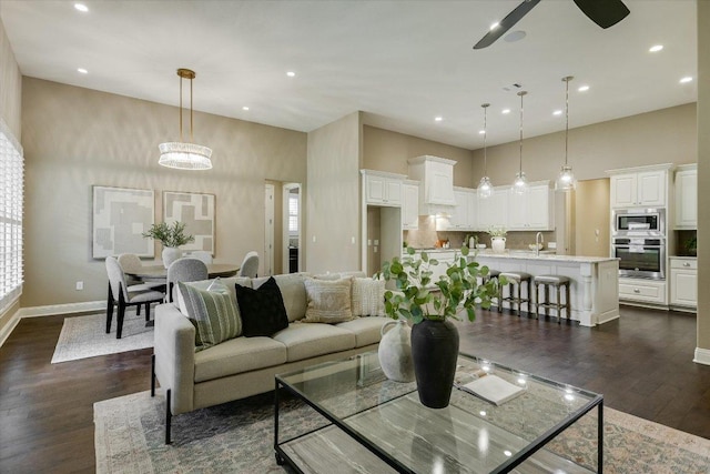 2421 Parisio Ct, Leander, TX 78641 - living room with dark wood-style flooring, recessed lighting, a high ceiling, a ceiling fan, and plenty of natural light
