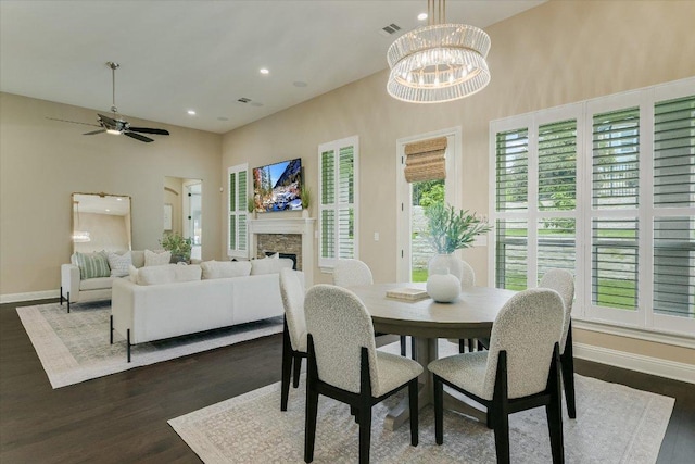 2421 Parisio Ct, Leander, TX 78641 - dining space with visible vents, a high ceiling, dark wood-style floors, and a fireplace