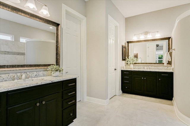 2421 Parisio Ct, Leander, TX 78641 - full bathroom featuring two vanities and tile patterned flooring