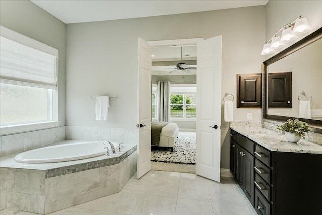 2421 Parisio Ct, Leander, TX 78641 - bathroom with vanity, ensuite bathroom, tile patterned floors, a bath, and a ceiling fan