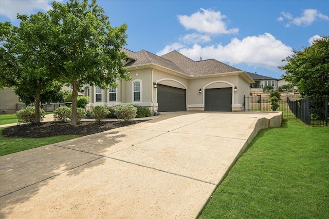 2421 Parisio Ct, Leander, TX 78641 - mediterranean / spanish house featuring fence, a garage, stucco siding, a front yard, and driveway
