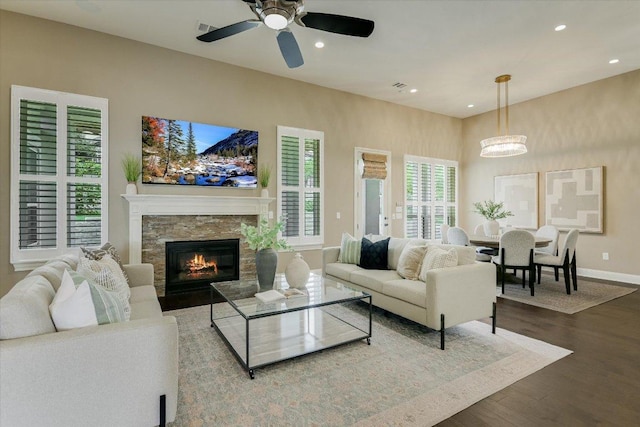 2421 Parisio Ct, Leander, TX 78641 - living area with wood finished floors, recessed lighting, a stone fireplace, and ceiling fan