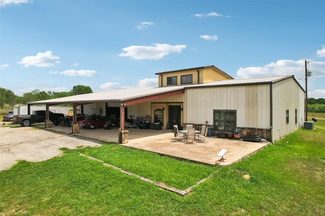 2300 Tumbleweed Trl, Dale, TX 78616 - back of property featuring a lawn, a carport, and a metal roof