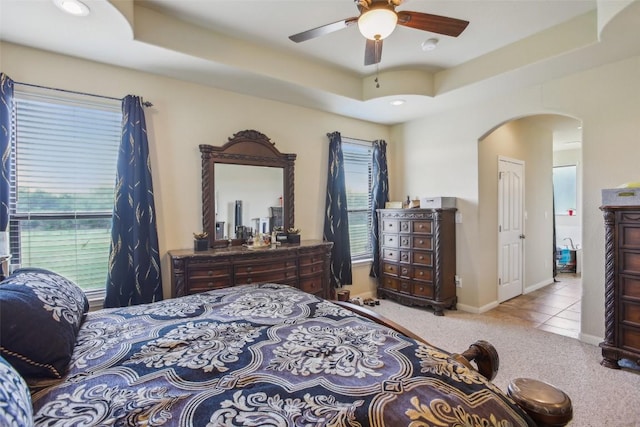 2300 Tumbleweed Trl, Dale, TX 78616 - carpeted bedroom with arched walkways, a raised ceiling, and a ceiling fan