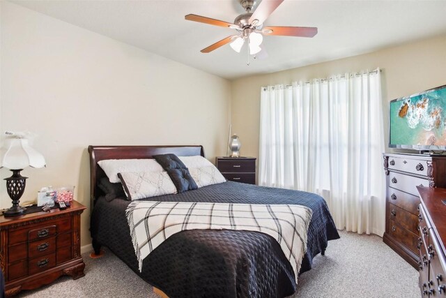 bedroom with a ceiling fan and carpet