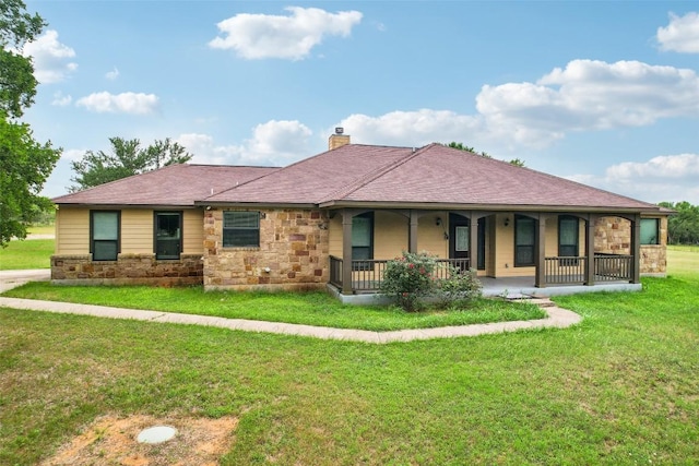 view of front facade featuring a porch, a chimney, stone siding, and a front lawn