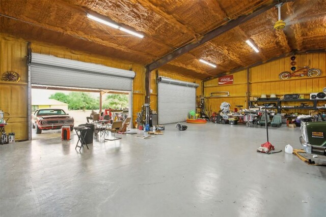 garage featuring wood walls