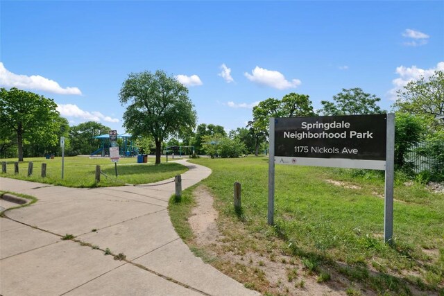 view of property's community featuring a yard and playground community