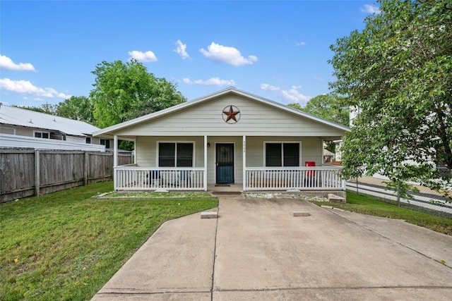 bungalow with fence, a porch, and a front lawn