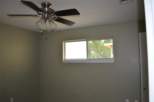 spare room with visible vents and a ceiling fan