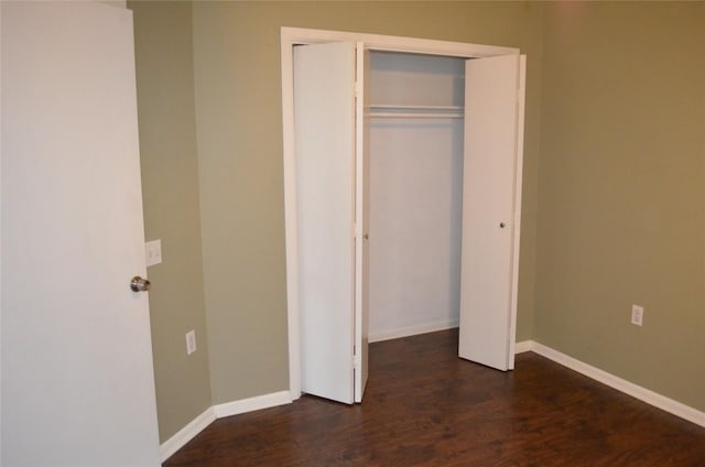 5009 Lott Ave, Austin, TX 78721 - unfurnished bedroom with dark wood-type flooring, a closet, and baseboards