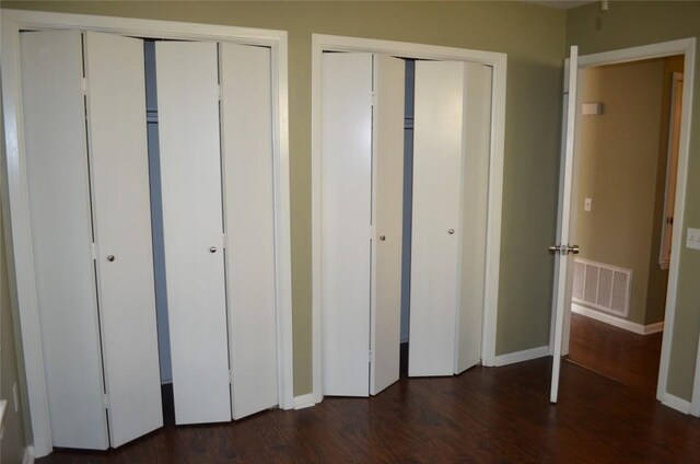 5009 Lott Ave, Austin, TX 78721 - unfurnished bedroom with multiple closets, wood finished floors, and baseboards