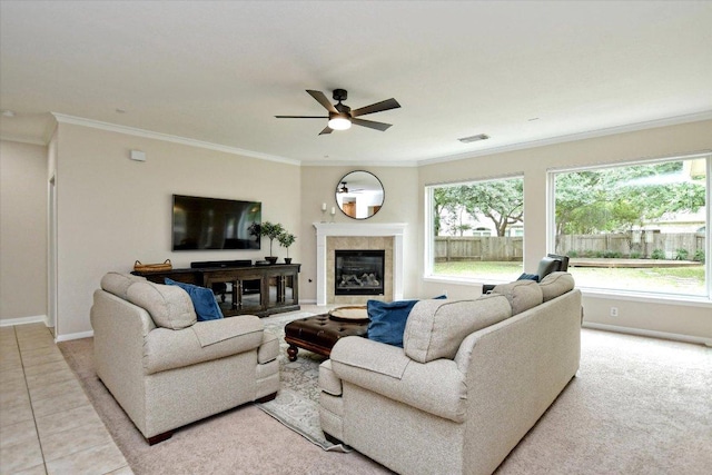 tiled living room with plenty of natural light, ornamental molding, baseboards, and ceiling fan